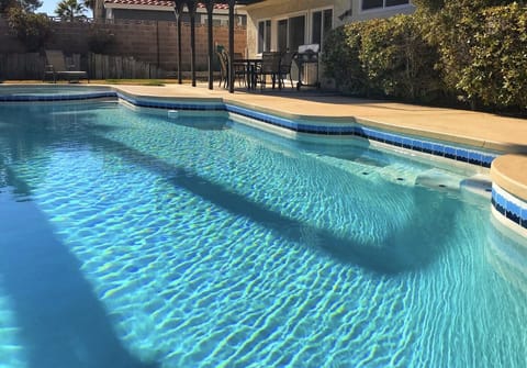 Private pool inn backyard with strip view
