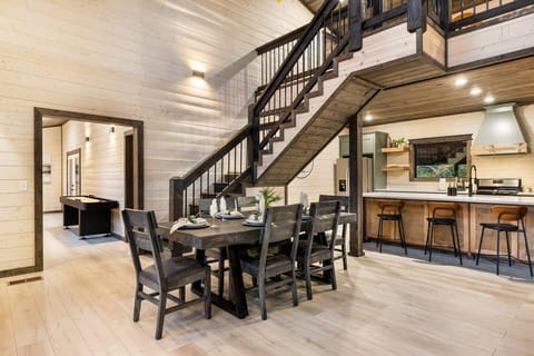 Dine in the dining area at the table for 6 with additional seats for 4 at the kitchen island.