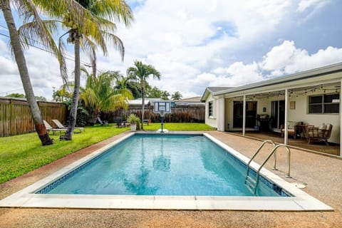 Who`s up for a game of pool basketball? This backyard has it all: a refreshing pool to cool off in and a basketball hoop to stay active.