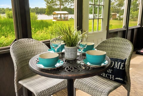 Screened in porch with dining set over-looking the water!