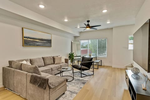 Unwind in the bright living room with a plush sectional, chic decor, and natural light 🌿🛋️✨