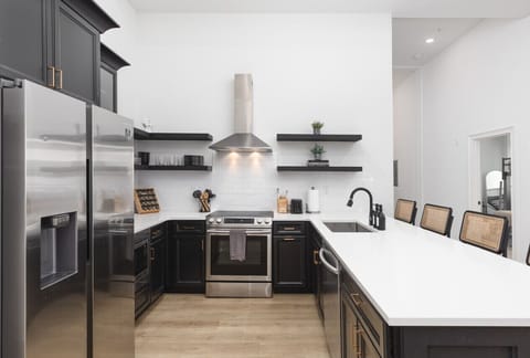 The kitchen is fully stocked with high-end appliances and every utensil, dish, and spice you might need to make a meal. Seating for four available at the counter.