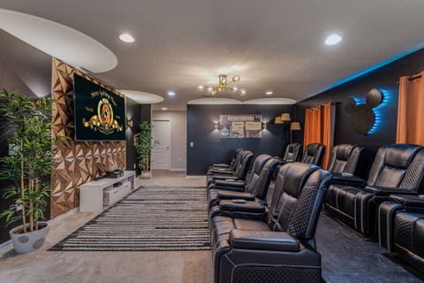 Private theater room featuring 9 plush leather recliners with built-in massage controls—your ultimate movie night experience!