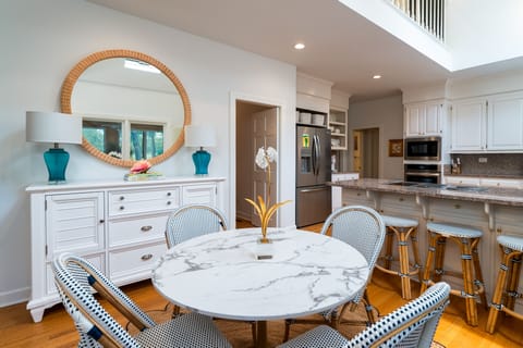 The kitchen anchors the back of the house. A breakfast table seats four and the counter has five sttols