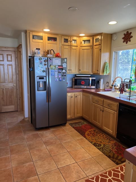 Kitchen with two-door frig, ice maker, microwave, Keurig k-duo coffee maker.