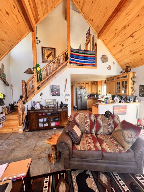 Great room, kitchen and stairs to loft/MBR showing doorless entry to loft.