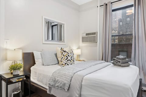The second bedroom has a full-size bed and air conditioning.