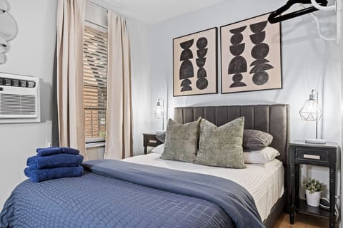 A snug double bed with fluffy pillows