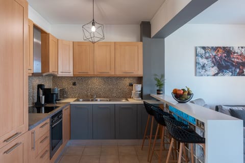The fully equipped kitchen features all essential appliances, with a breakfast bar adorned