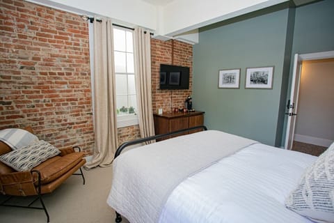 Sleep in ultimate comfort on our Queen Bed, adorned with luxurious linens for a restful, indulgent experience.
