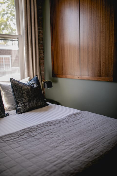 Spacious Queen Suite featuring a comfortable queen-sized bed, stylish living area, and upscale amenities for a refined and relaxing retreat.