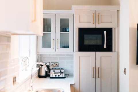 Trinity Suite | Living area | 55-inch LED TV with satellite channels, DVD player