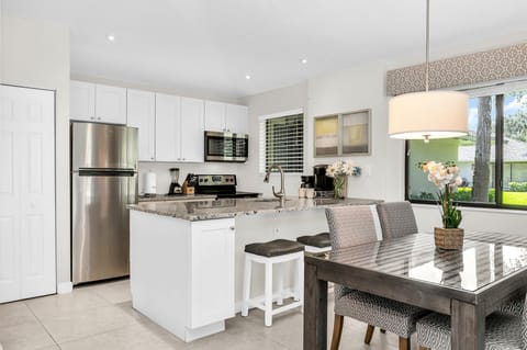 This remarkable open-plan kitchen boasts luxury and impeccable style. Fit with modern white shaker cabinets, and granite counters, stainless steel appliances, a filter coffee brewer, a Keurig, a blender, dinnerware service for 6, and everything you need.