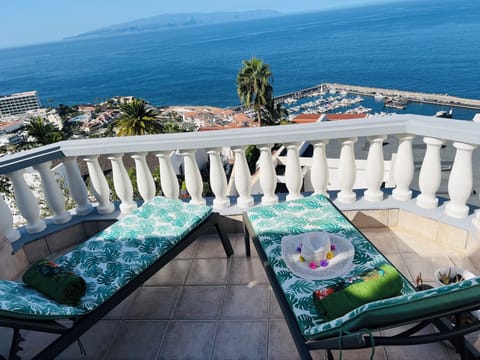 Sunny terrace with 2 sun loungers and table and 4 chairs