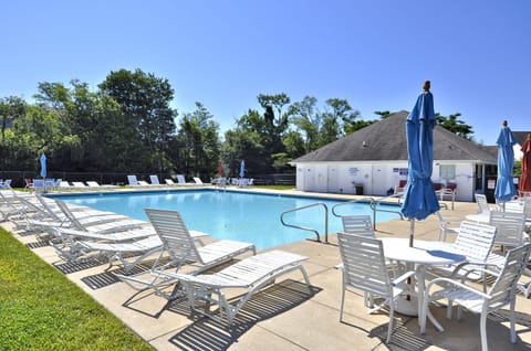 38157 Greenport Lane, South Hampton, Ocean View-South Hampton Co - Pristine community swimming pool featuring ample lounge seating, patio tables with umbrellas, and a spacious sun deck.