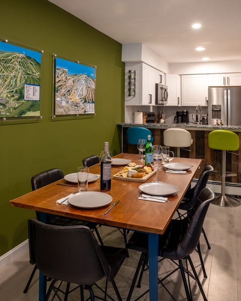 The dining table seats 6 with 3 additional spots at the breakfast bar. 