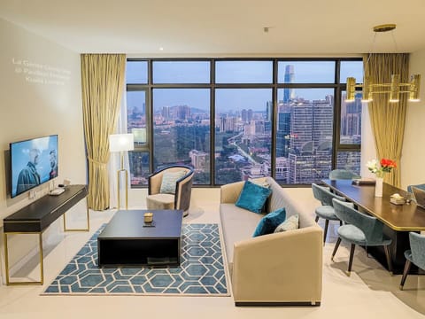 Spacious living room and dining area overlooking the KL city from high up in the sky. 

Designer furniture, 50" Samsung 4K TV, large dining table, comfy seats, great lighting, amazing views, comfortable space, your luxury home away from home.