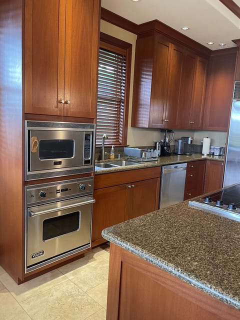 Built in oven and microwave with stove top on island.