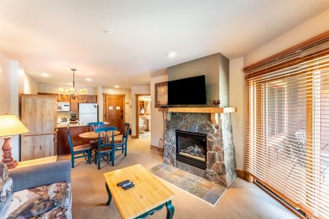 Cozy up by your stone fireplace while preparing meals in your fully equipped kitchen—perfect for mountain getaway evenings.