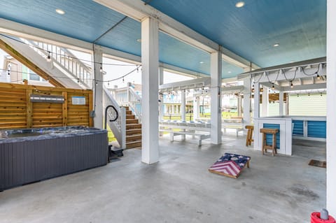 A hot tub, large games, tiki bar, tv, and plenty of seating adds more fun.