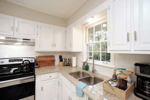 A stove with fully stocked cooking utensils.