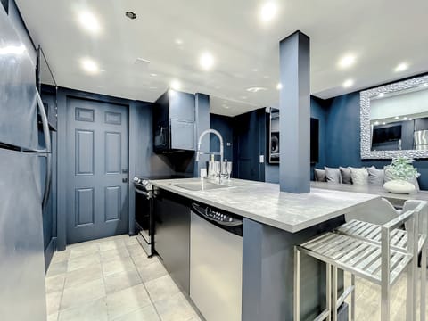 Full-size kitchen with brand new state-of-art Samsung stove, convection oven, air fryer, island bar with in-kitchen dining, entertaining 70-inch smart TV in the dining room, 50-inch in kitchen, stone dining table for up to 12 persons & bar seating.