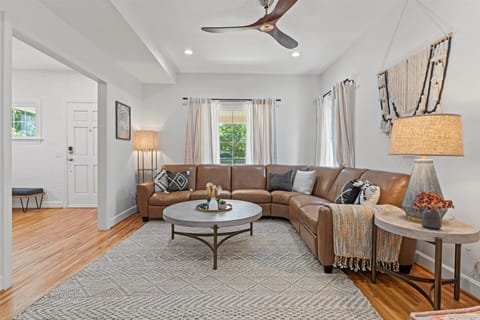 Spacious and stylish living room with a cozy sectional—perfect for relaxing after a day exploring Kansas City.
