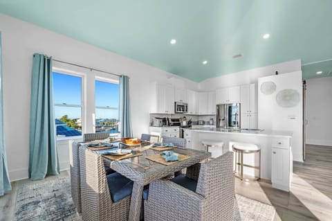 Upstairs kitchen and formal dining area with seating for six at the dining table and two at the bar