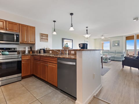 Your fully equipped kitchen flows seamlessly into the comfortable living space, perfect for preparing meals while staying connected with your group.
