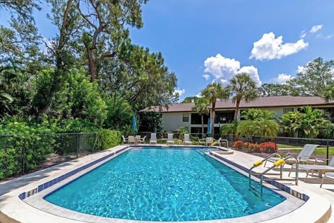 Heated Pool With Condo In Background On Ground Level.