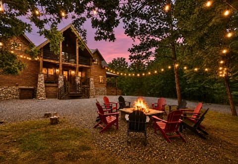 Evenings are made for gathering around the fire pit beneath the string lights, with plenty of seating for everyone to relax and enjoy the wooded surroundings.