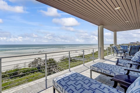 Oceanfront balcony with ample seating for breathtaking views.