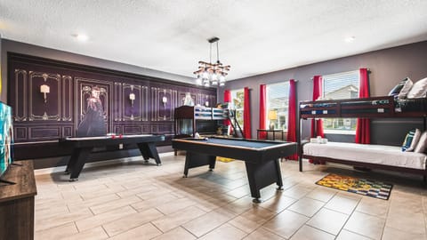 Enchanting game room with wizard decor, bunk beds, pool table and air hockey
