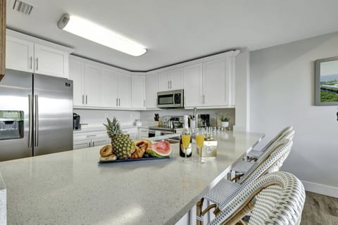 A pristine canvas of white cupboards elegantly lines the walls, creating a sense of purity and sophistication.