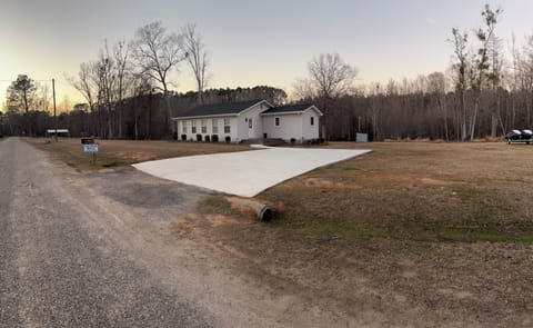 Front of house. 40ft x 22ft concrete area. Extra parking to right.