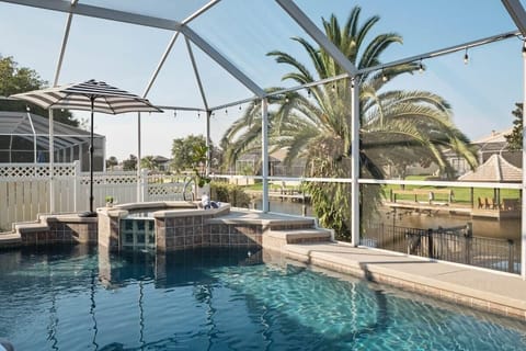 Resort-style pool with comfortable loungers and canal backdrop