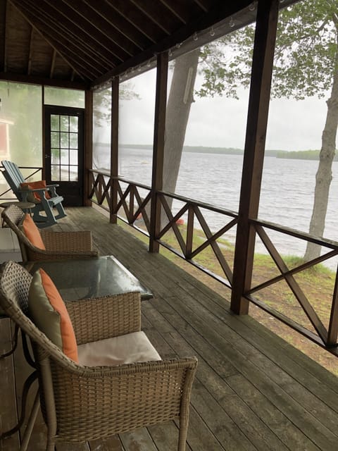 Seating area on screened in porch.