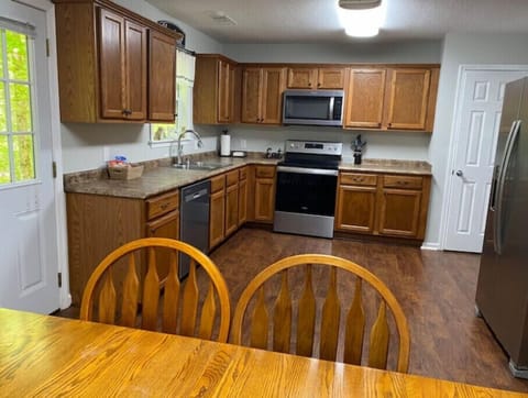 Kitchen with amenities and a Coffee Bar located on far side of refrigerator.