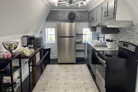 Fully stocked kitchen has ample dishes, glasses, silverware, bowls, pots and pans for quick food on the run or full meals.