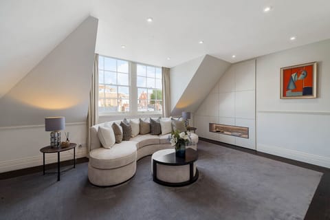 Living room — quality carpet and hardwood floor finishes with double sofa bed, blackout blinds, central heating, and a large Smart TV. Sofa bed always made up and ready to use, with extra pillows and blankets provided