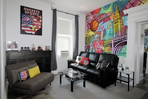 Grey pull out couch can turn into a twin bed. 