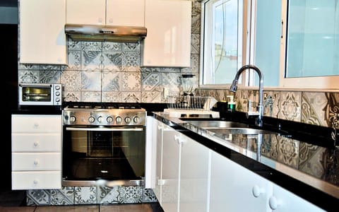 Spacious kitchen with basic appliances ready to prepare delicious food.