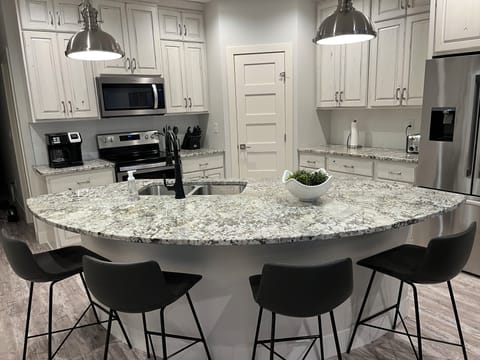 Fully furnished kitchen with island seating for four