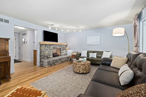 First of two spacious and comfortable living rooms complete with sleeper sofa, decorative fireplace, piano and room to spread out and entertain.