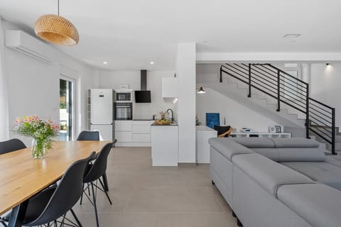 a stylish living area (42sqm) with flat screen TV, A/C, direct exit to outdoor dining area and pool
