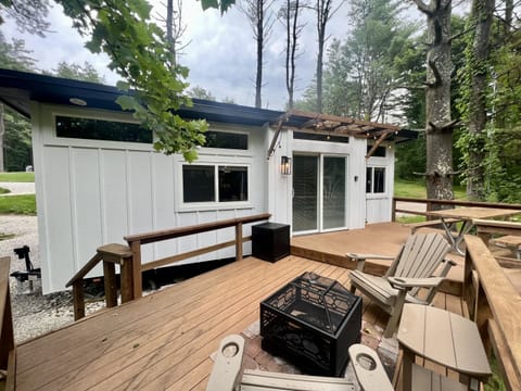 The large deck includes a fire pit with two Adirondack chairs, and a picnic table for eating a tiny-home-cooked meal or takeout from one of the many great nearby restaurants.