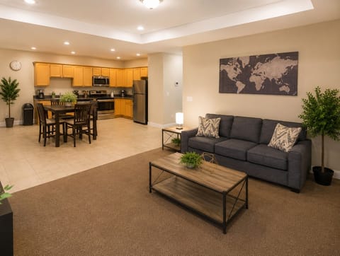 Spacious open living area with full kitchen, dining table, and cozy seating
