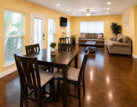 Bright open-concept living & dining area with cozy seating and natural light