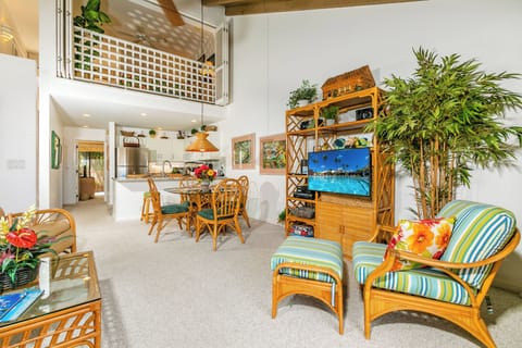 Relax in your bright, open living space with soaring ceilings, tropical bamboo furnishings, and vibrant island décor. The airy loft, full kitchen, and cozy seating create the perfect tropical retreat for your stay.