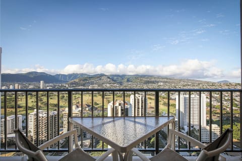 Sweeping mountain and cityscape views frame this private balcony, where you can enjoy morning coffee or evening relaxation with Hawaii's dramatic landscape stretching before you.
